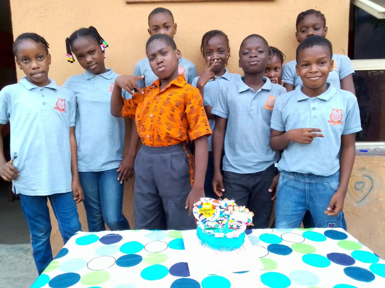 Pupils gathered around a Children's Day cake