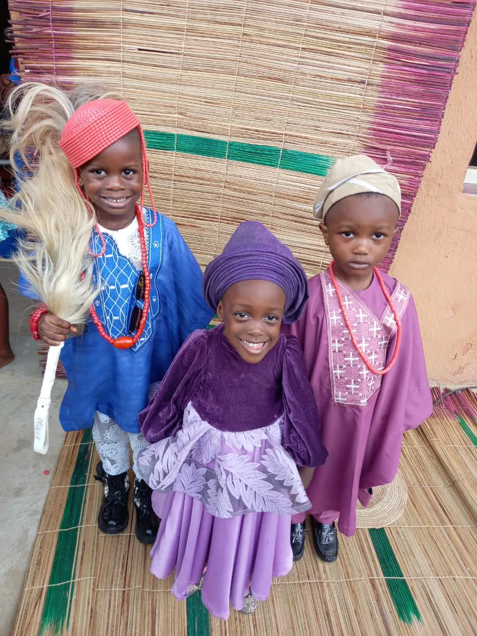 Three children in traditional outfits on Cultural Day